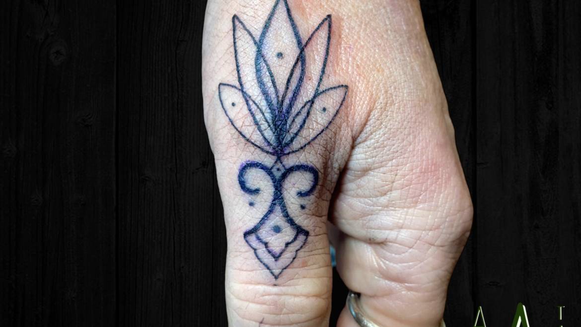 Ornamental thumb tattoo